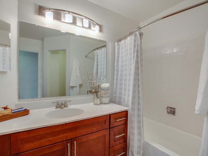 This image shows the premium apartment feature, particularly the bathroom area featuring a ceramic tile throughout the foyer and walk-in shower.