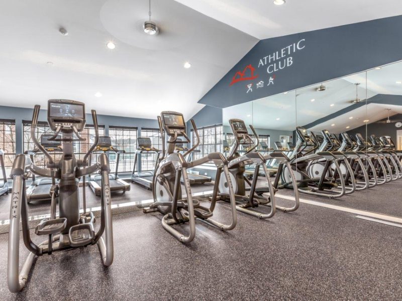 This image showcases the commercial fitness with State-of-the-art athletic club with equipment that is essential for community amenities and offering a high-quality cardio machine.