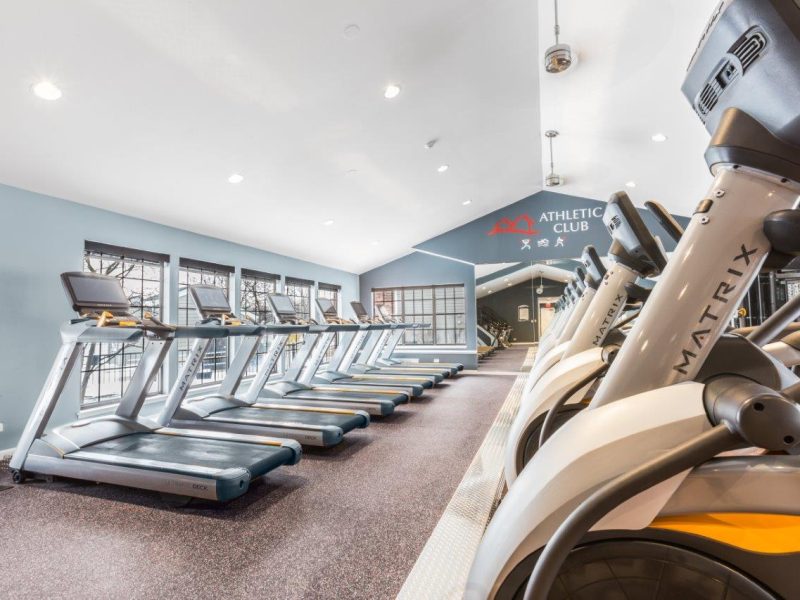 This image shows an expansive view of the fitness gym equipment featuring the yoga and spin studio with indoor cycling mirror that was ideal for flexibility and strength exercise.