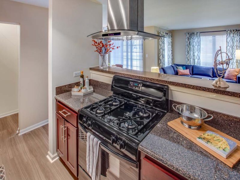 This image shows fully equipped gourmet kitchens with high-end finishes and contemporary whirlpool appliances.