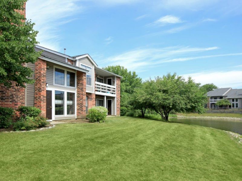 This image shows an outdoor landscape view of the TGM Willowbrook pondside that features a superb and sophisticated green surrounding.