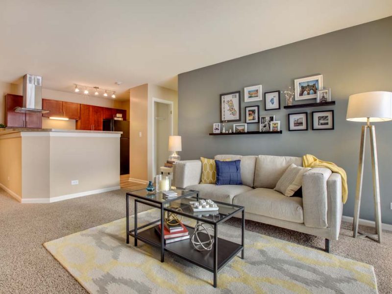 This image shows an expansive living room area with USB outlets that overview the kitchen island.