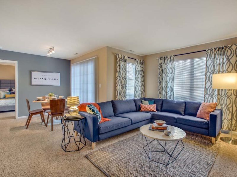 This image shows the landscape view of the living area featuring easy access from the dining room to the bedroom.